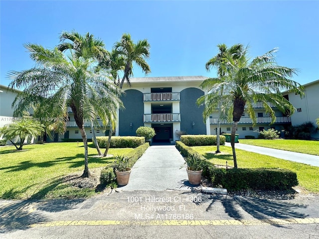 1001 Hillcrest Ct Unit 306, Hollywood, FL 33021 - view of front facade with a balcony, a front yard, and stucco siding