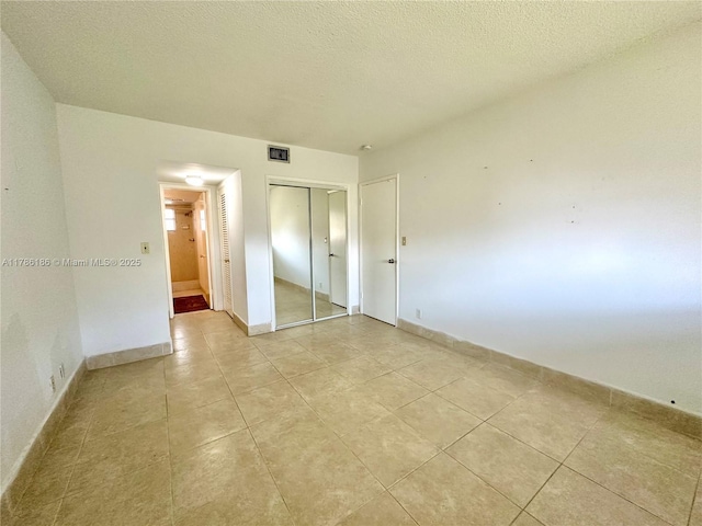 1001 Hillcrest Ct Unit 306, Hollywood, FL 33021 - unfurnished bedroom featuring baseboards, a closet, and light tile patterned floors