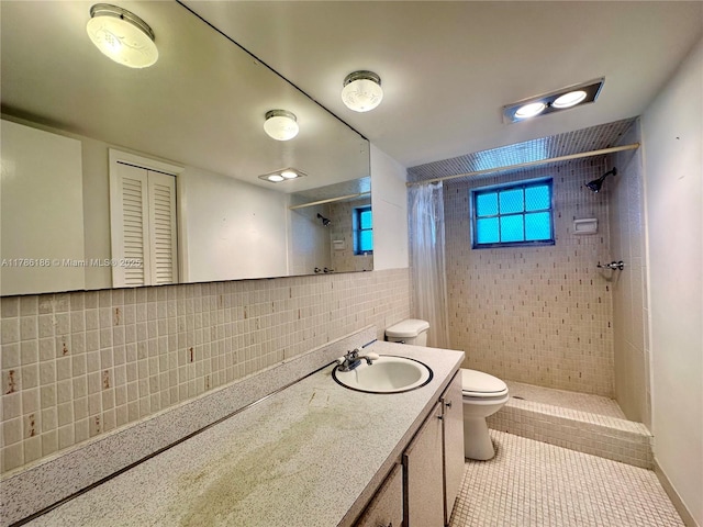 1001 Hillcrest Ct Unit 306, Hollywood, FL 33021 - bathroom with a tile shower, tile patterned flooring, toilet, vanity, and tile walls