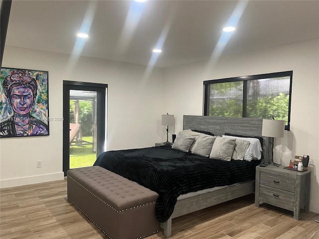 bedroom with light wood-type flooring and baseboards