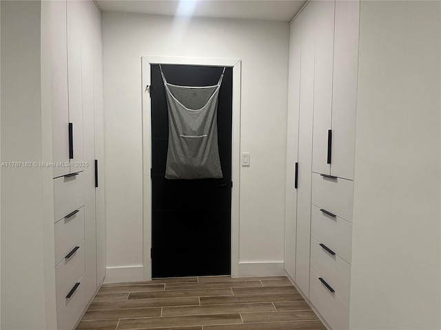 interior space with wood tiled floor and baseboards