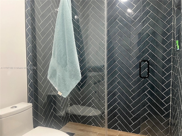 full bath with toilet and a shower stall