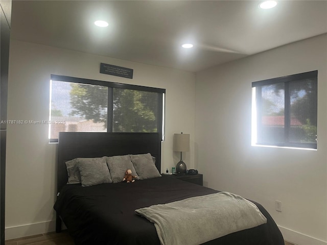 bedroom featuring baseboards, recessed lighting, and wood finished floors