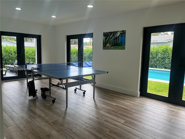 playroom with plenty of natural light, french doors, and wood finished floors