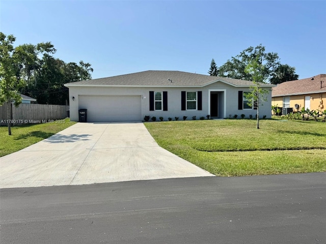 749 SE Karrigan Ter, Port St Lucie, FL 34983 - ranch-style house featuring a garage, stucco siding, and driveway