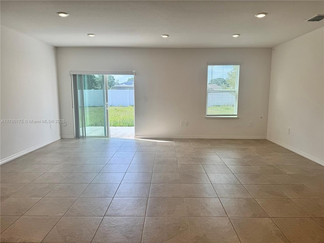 749 SE Karrigan Ter, Port St Lucie, FL 34983 - empty room with plenty of natural light, tile patterned flooring, recessed lighting, and baseboards