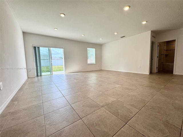 749 SE Karrigan Ter, Port St Lucie, FL 34983 - spare room featuring recessed lighting, light tile patterned flooring, and baseboards