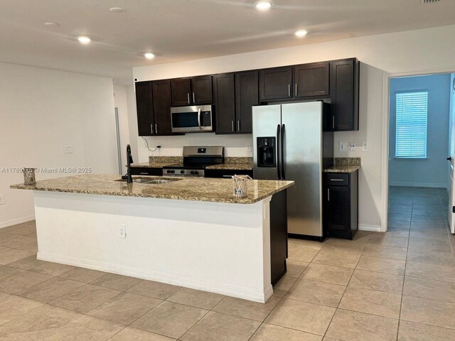 749 SE Karrigan Ter, Port St Lucie, FL 34983 - kitchen featuring stainless steel appliances, a sink, a kitchen island with sink, light stone countertops, and recessed lighting