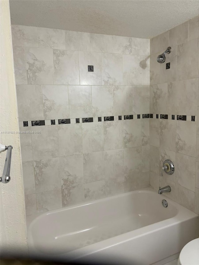 20311 NE 2nd Ave Unit 27, Miami, FL 33179 - full bathroom featuring shower / washtub combination, toilet, and a textured ceiling