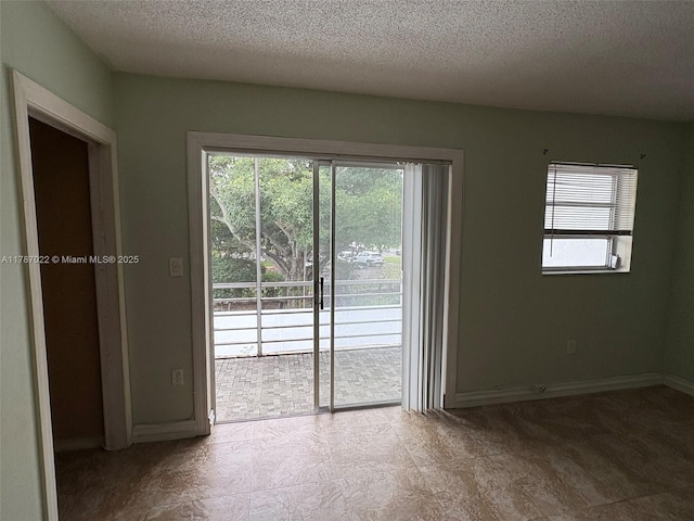 20311 NE 2nd Ave Unit 27, Miami, FL 33179 - unfurnished room featuring a textured ceiling and baseboards