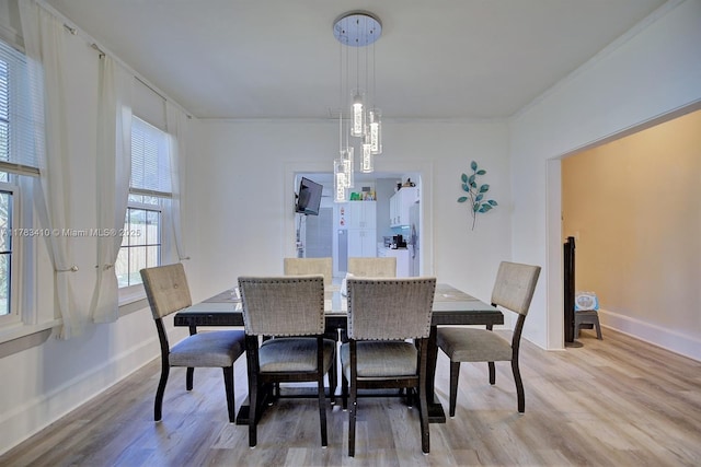 121 E Walnut St, Avon Park, FL 33825 - dining room with baseboards, light wood-style floors, and ornamental molding
