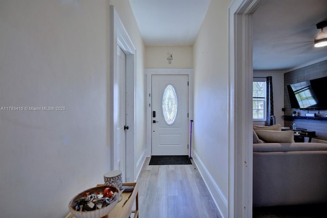 121 E Walnut St, Avon Park, FL 33825 - doorway to outside featuring wood finished floors and baseboards