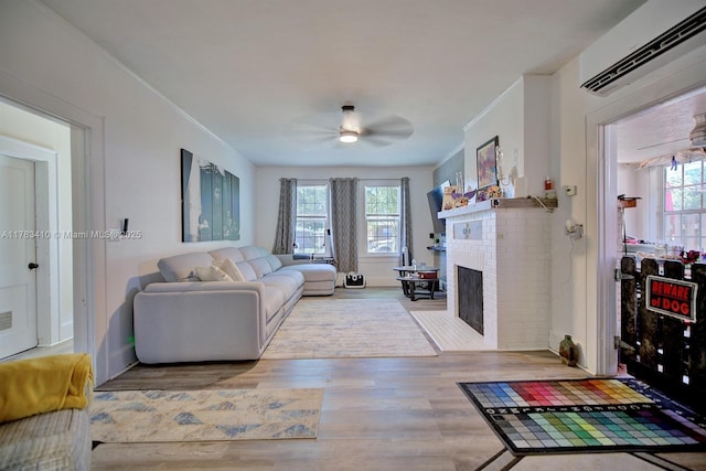 121 E Walnut St, Avon Park, FL 33825 - living area with a wall mounted air conditioner, ceiling fan, wood finished floors, and a brick fireplace