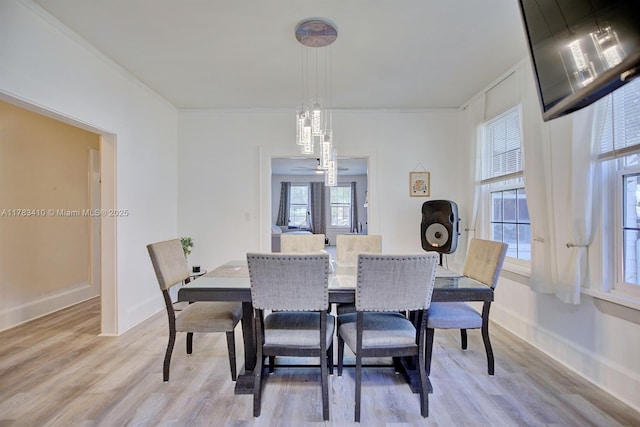121 E Walnut St, Avon Park, FL 33825 - dining space with light wood-style floors, baseboards, and ornamental molding