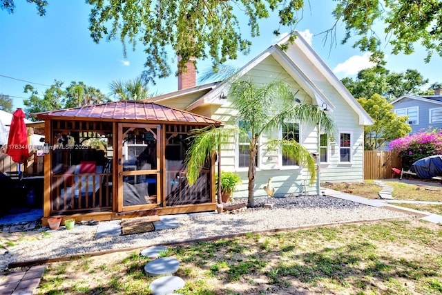 121 E Walnut St, Avon Park, FL 33825 - back of house featuring a chimney, metal roof, and a standing seam roof