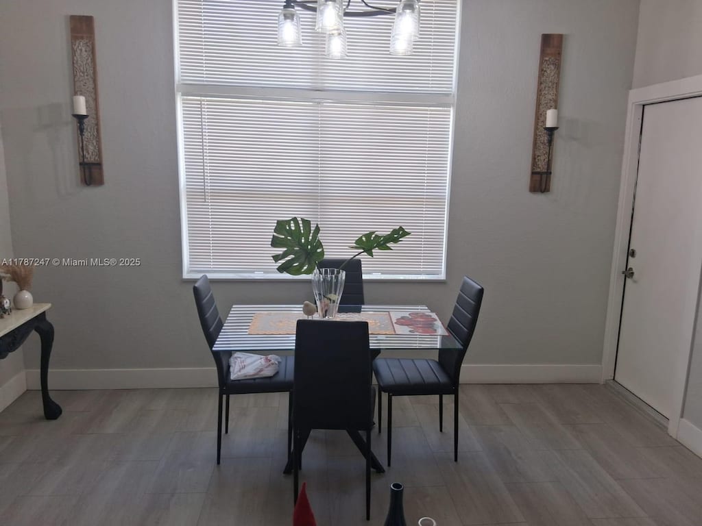 dining room featuring light wood-style floors and baseboards