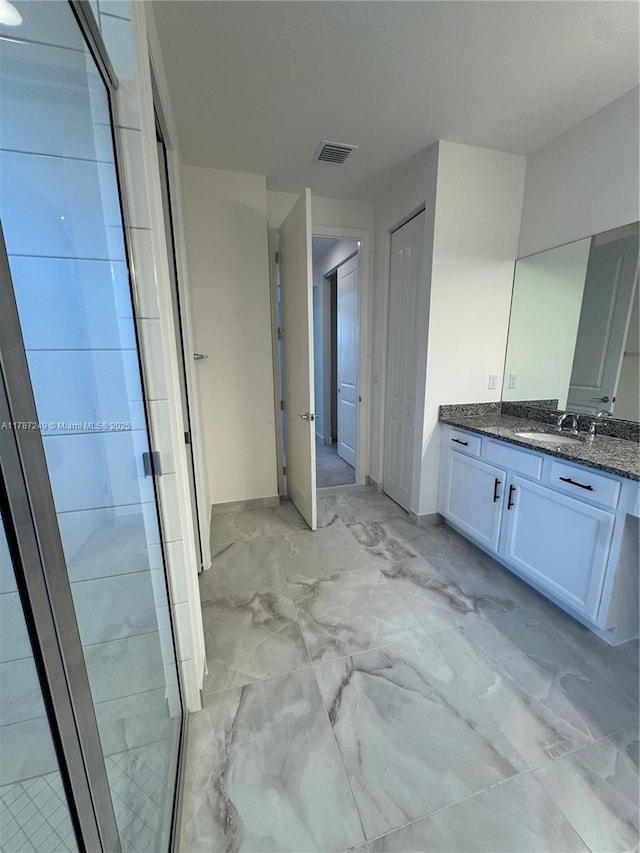 bathroom featuring marble finish floor, visible vents, vanity, and a stall shower