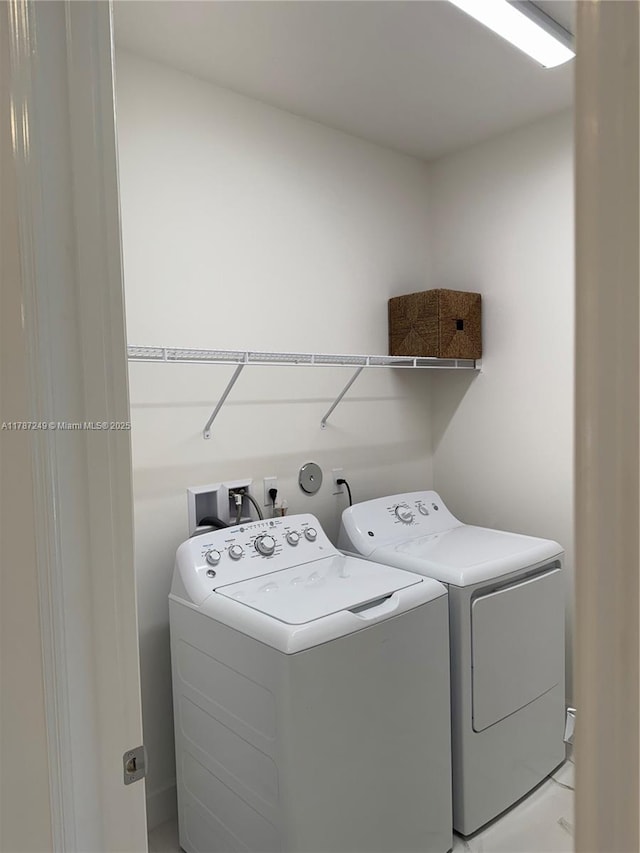 laundry room with separate washer and dryer and laundry area