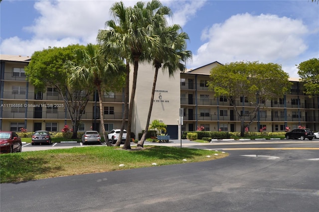 view of building exterior with uncovered parking