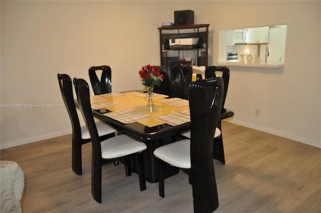 700 SW 128th Ave Unit 106C, Pembroke Pines, FL 33027 - dining room featuring baseboards and wood finished floors