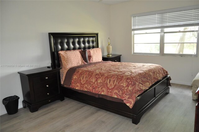 700 SW 128th Ave Unit 106C, Pembroke Pines, FL 33027 - bedroom featuring wood finished floors and baseboards
