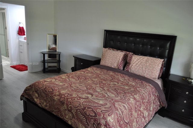 bedroom with baseboards and wood finished floors