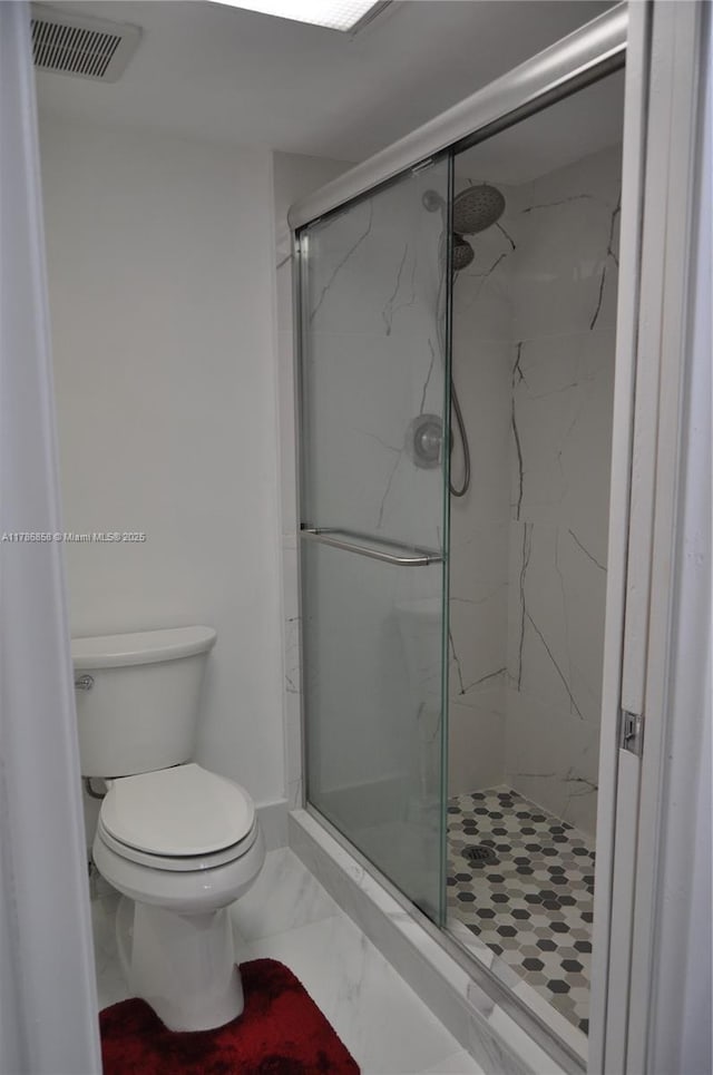 700 SW 128th Ave Unit 106C, Pembroke Pines, FL 33027 - full bathroom featuring a marble finish shower, marble look tile flooring, and toilet