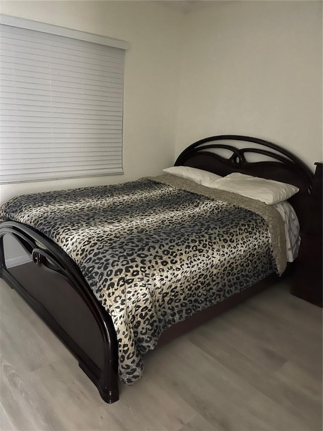 bedroom featuring wood finished floors