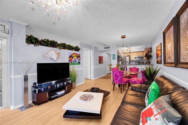 1280 S Alhambra Cir Unit 1207, Coral Gables, FL 33146 - living room featuring a chandelier, light wood-style floors, and a textured ceiling