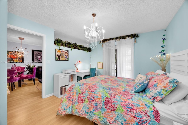 1280 S Alhambra Cir Unit 1207, Coral Gables, FL 33146 - bedroom featuring a chandelier, light wood-type flooring, and a textured ceiling