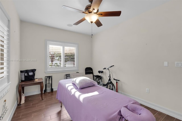 bedroom with baseboards, wood finished floors, and ceiling fan