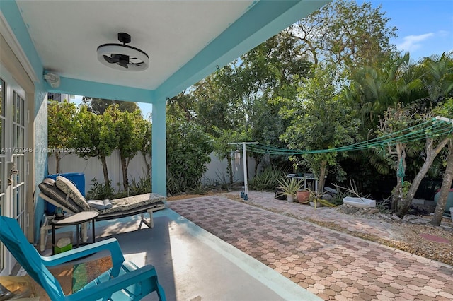 view of patio with a fenced backyard and a ceiling fan
