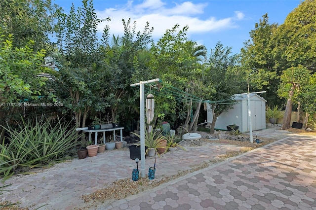 view of patio with an outbuilding and a shed