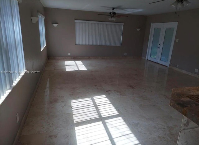 spare room with ceiling fan and french doors