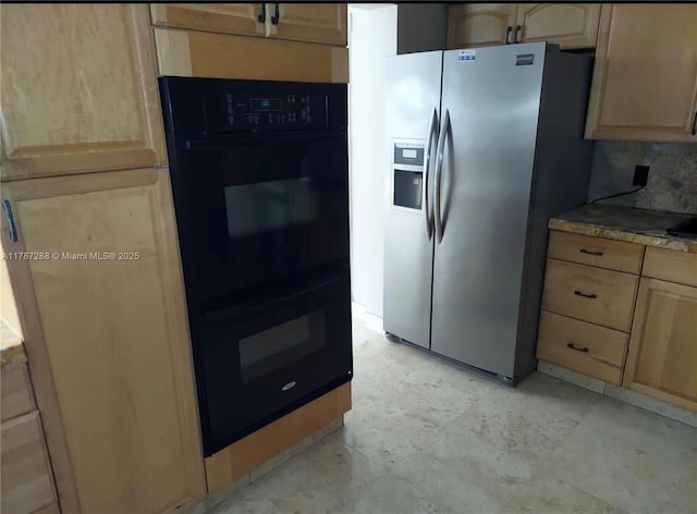 kitchen featuring light brown cabinets, light countertops, stainless steel fridge, and dobule oven black