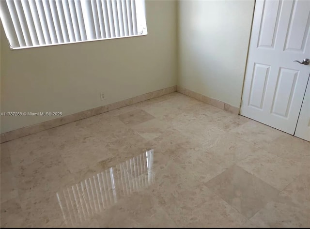 empty room with baseboards