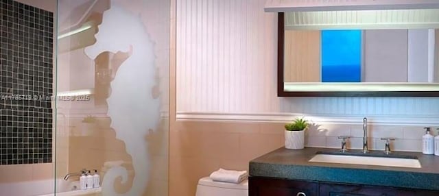17315 Collins Ave Unit 1806, Sunny Isles Beach, FL 33160 - bathroom featuring shower / washtub combination, toilet, vanity, tile walls, and decorative backsplash