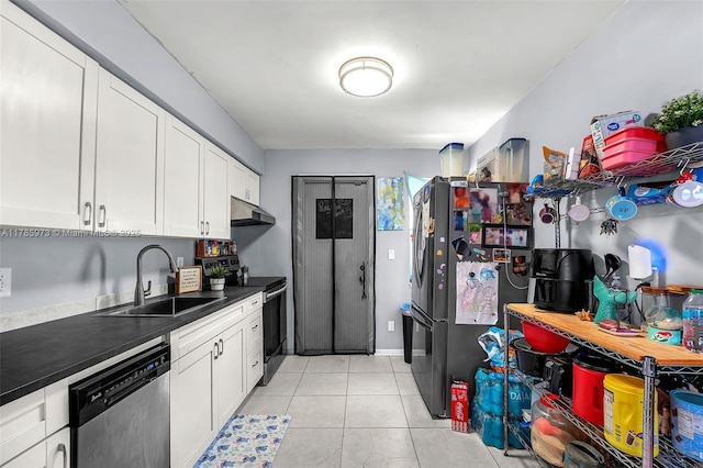 kitchen with dark countertops, a sink, stainless steel appliances, white cabinetry, and under cabinet range hood