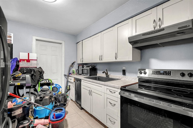 kitchen with a sink, light countertops, electric range, under cabinet range hood, and dishwashing machine