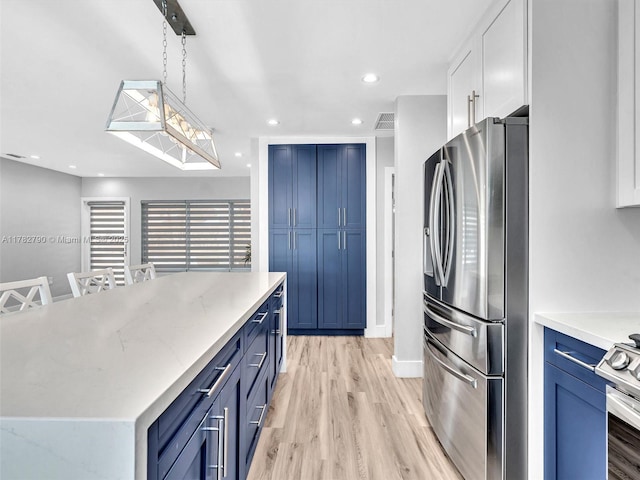 kitchen featuring blue cabinetry, appliances with stainless steel finishes, light wood finished floors, and visible vents