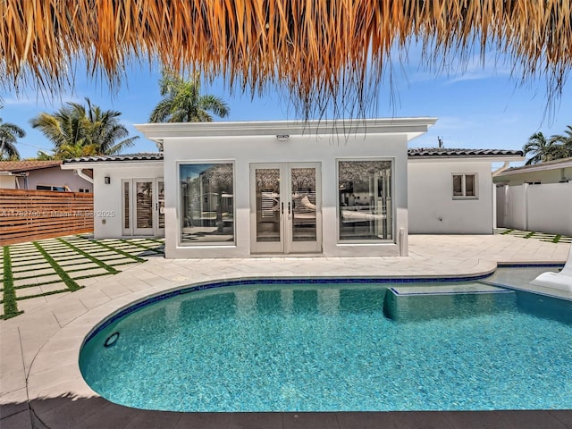 view of pool with fence, a patio area, a fenced in pool, and french doors