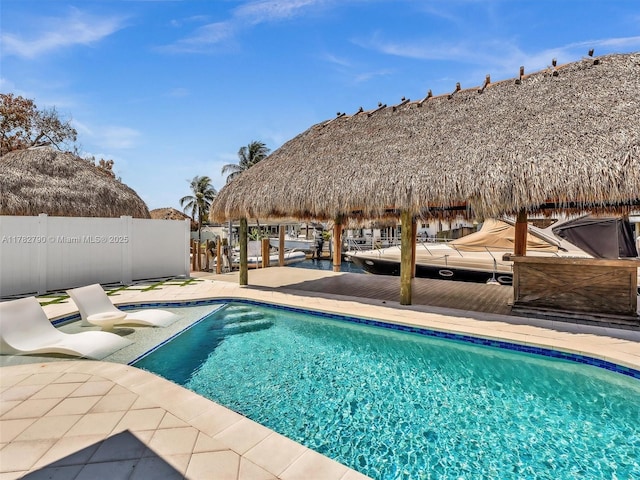 view of swimming pool featuring fence, a fenced in pool, a gazebo, and a patio