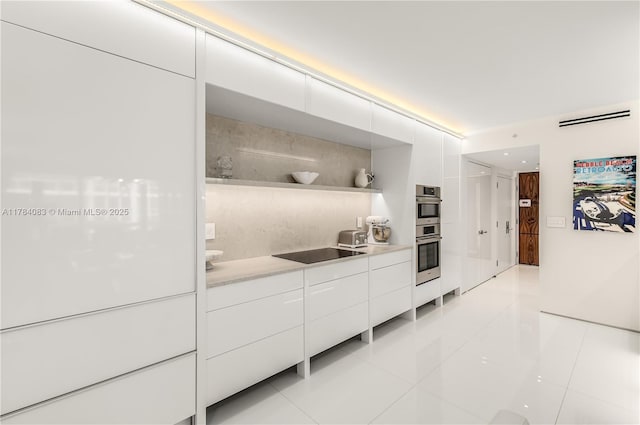 10205 Collins Ave Unit 1106, Bal Harbour, FL 33154 - kitchen featuring modern cabinets, white cabinets, light tile patterned flooring, black electric cooktop, and light countertops