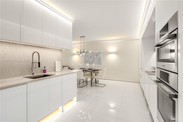10205 Collins Ave Unit 1106, Bal Harbour, FL 33154 - kitchen with a sink, modern cabinets, and white cabinets