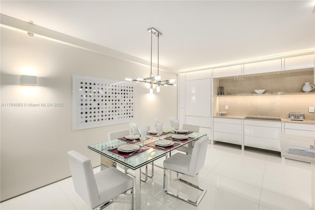 10205 Collins Ave Unit 1106, Bal Harbour, FL 33154 - dining room featuring light tile patterned floors and a chandelier