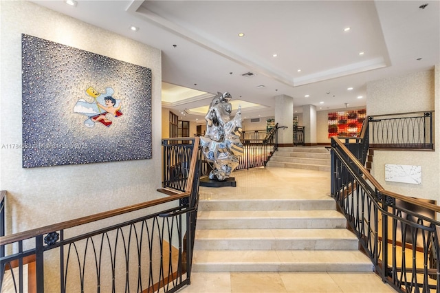 10205 Collins Ave Unit 1106, Bal Harbour, FL 33154 - stairs with a tray ceiling and recessed lighting