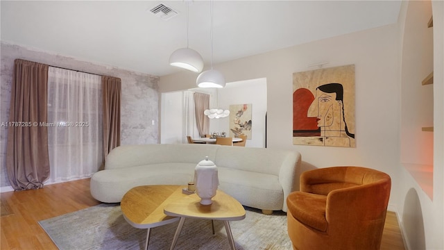 living area featuring wood finished floors and visible vents