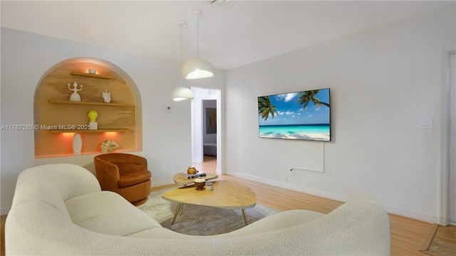 living room featuring baseboards and wood finished floors
