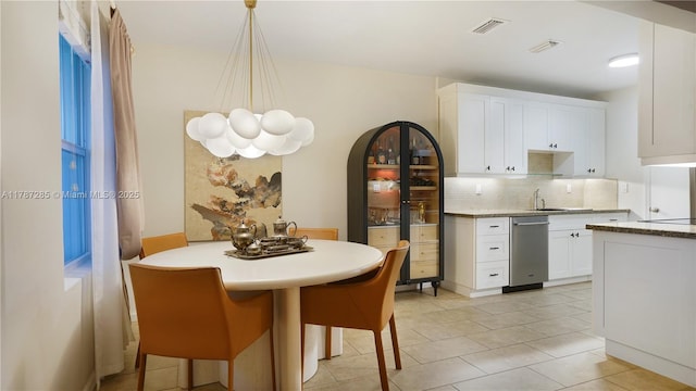 dining room with an inviting chandelier, visible vents, and light tile patterned floors