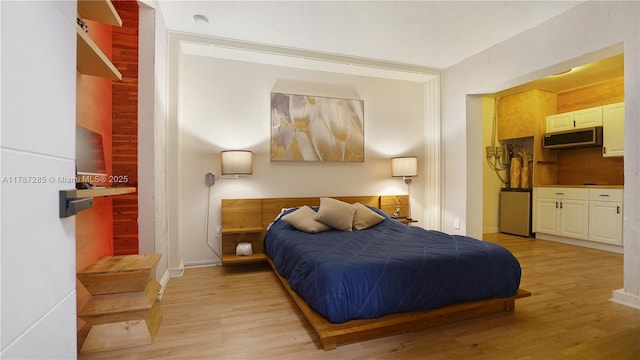 bedroom featuring light wood-style floors and baseboards